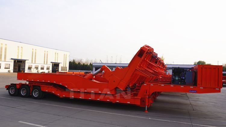 The wind blade trailer adopts the pulling structure to extend the length, and the wind blade lies flat on top of the trailer. The significant feature of the wind blade transport semi-trailer is that it is super long and has longitudinal expansion and contraction. Due to the super length of the vehicle type, the turning difficulty is significantly increased. To overcome driving on the curve, the wind blade transport vehicle is generally equipped with a hydraulic steering system, and the rear axle is fitted with a power station.